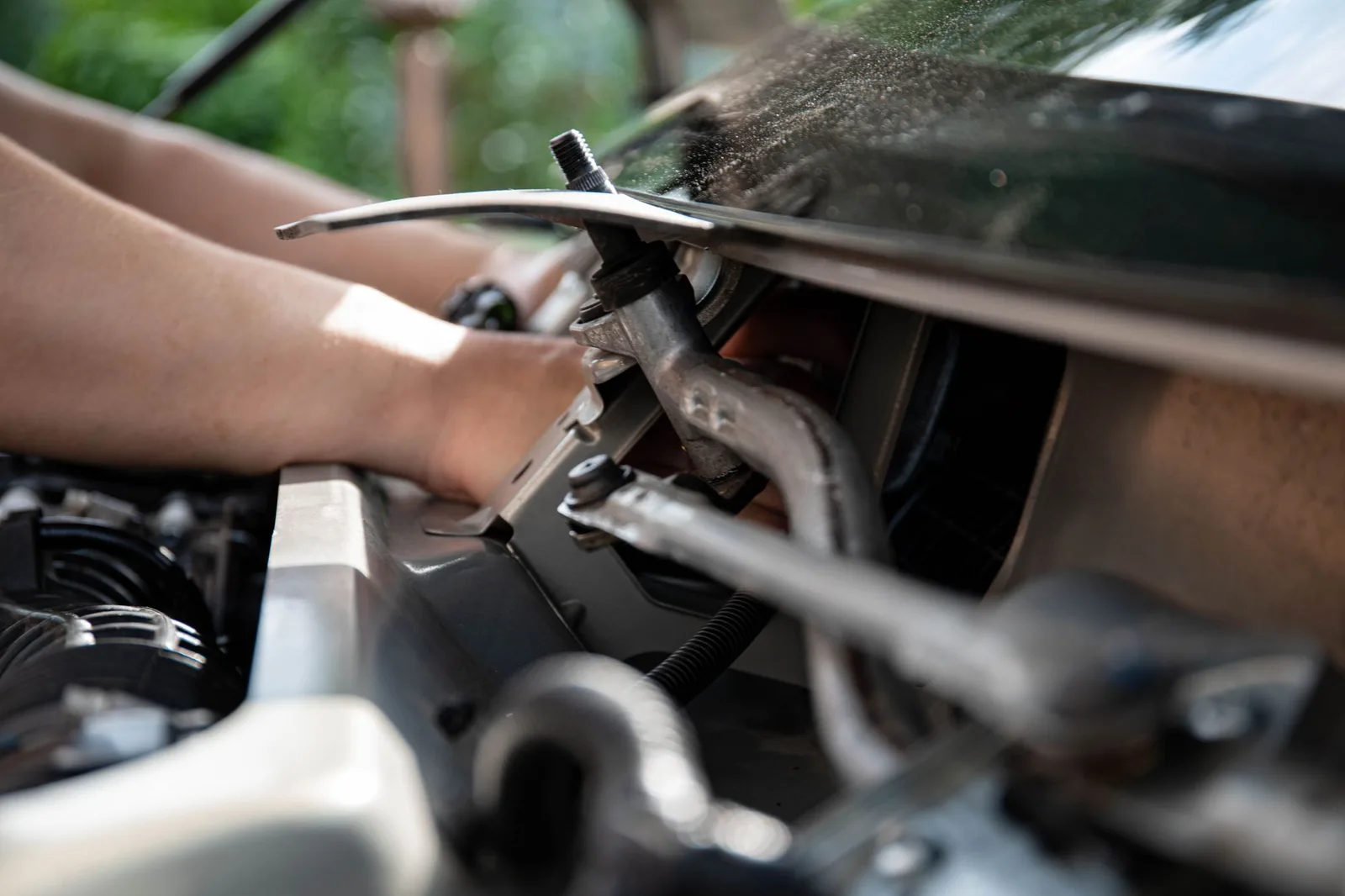 A technician working by hand on a mechanical component in a repair shop